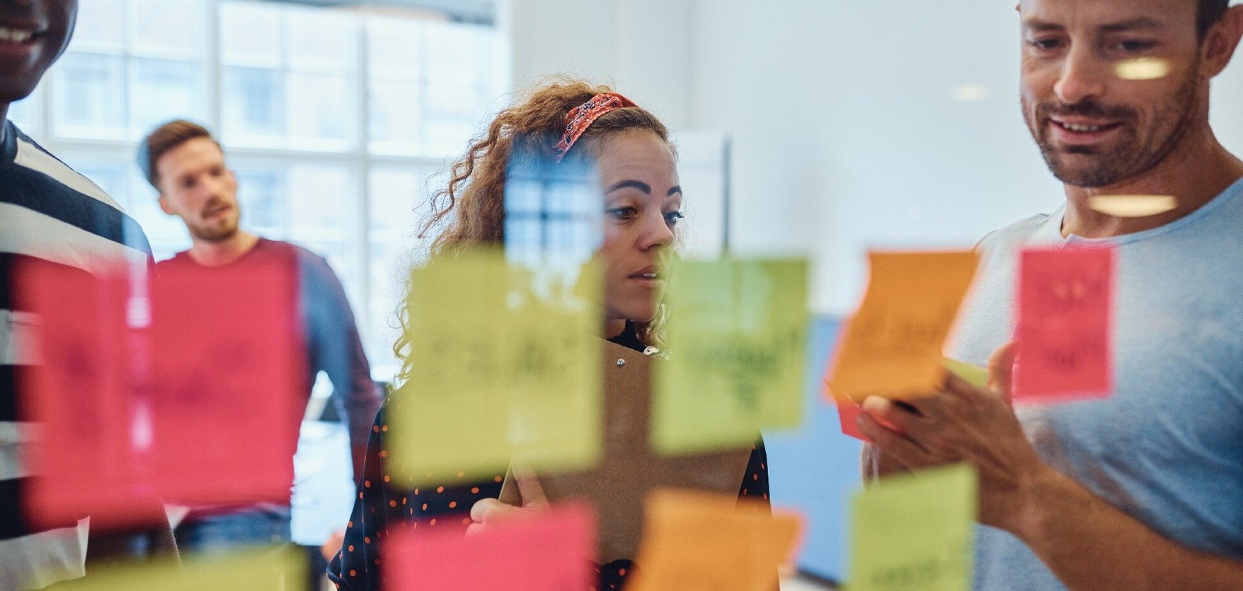 Team assessing ideas on post-its