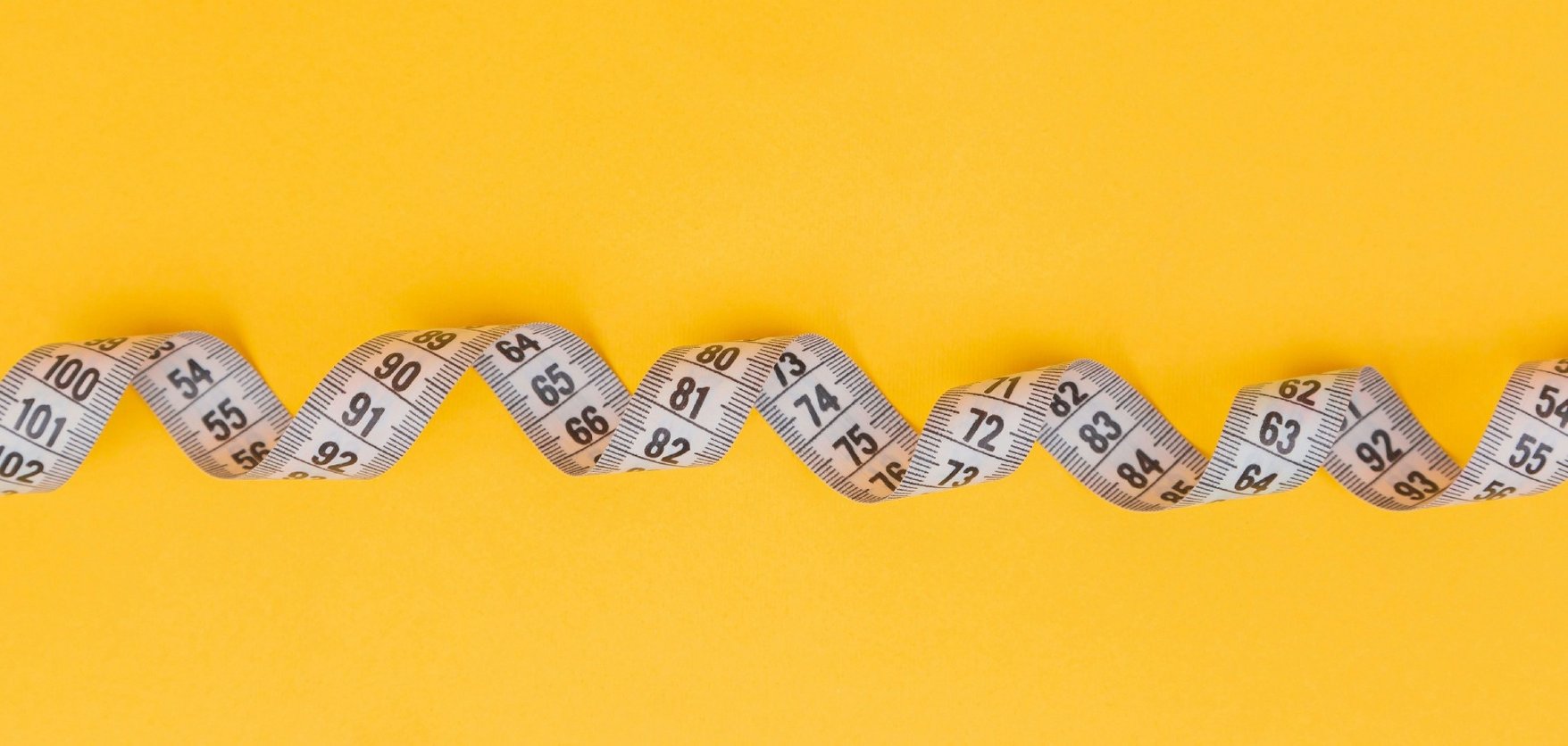 measuring tape on yellow background