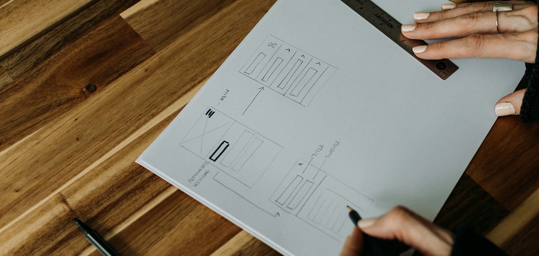 A close up of a person sketching in a notebook