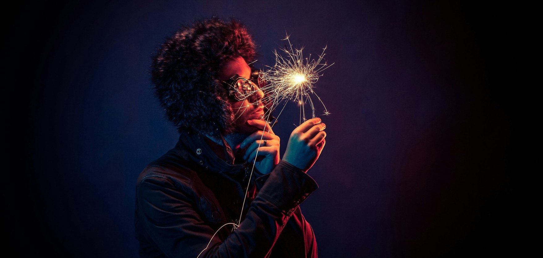 Man looking at sparkler representing innovative ideas